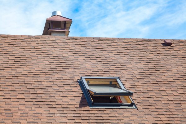 dreamstime_m_106308510 New roof with skylight, asphalt roofing shingles and chimney.